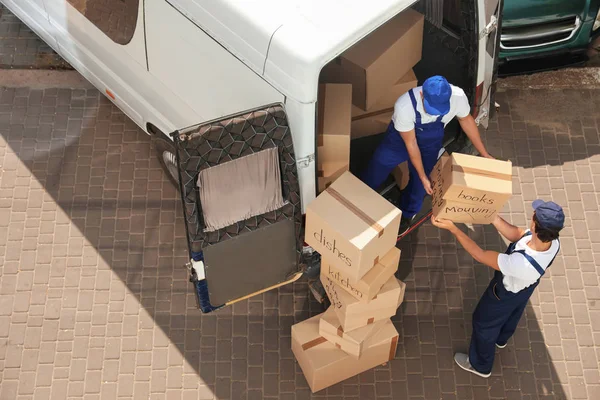 depositphotos_213086360-stock-photo-male-movers-unloading-boxes-van
